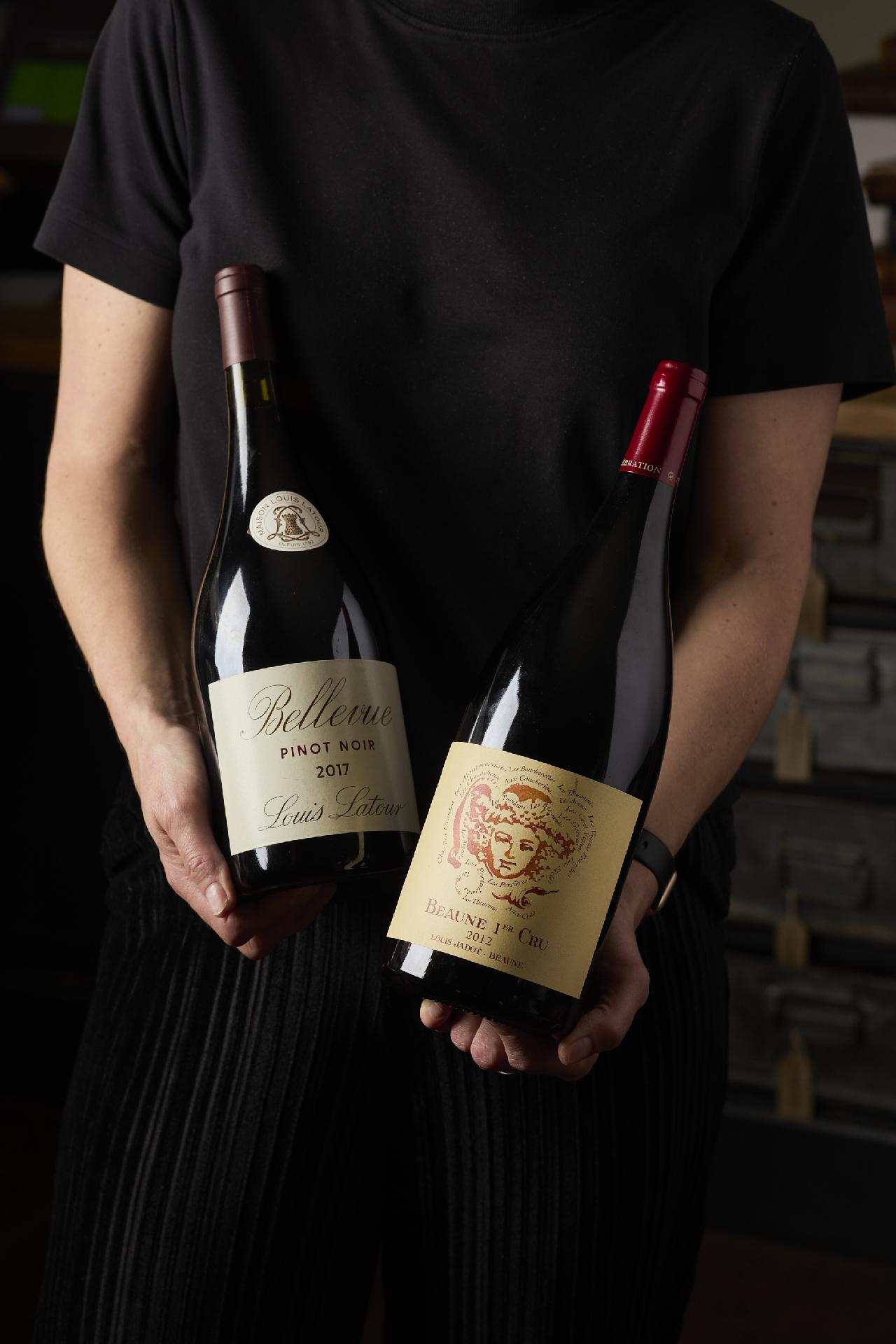 Two bottles of Red Wine being presented